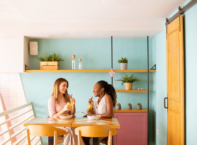 Two women enjoying drinks and conversation.